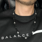 Stylish men’s necklace with Onyx, Clear Quartz, and Hematite, worn by a model, perfect accessory for professionals and ambitious individuals.